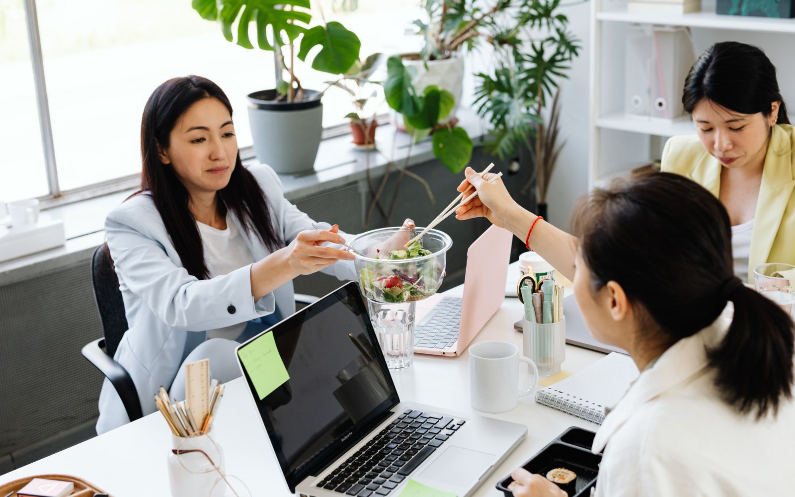 Colleagues sharing a healthy salad during a work break
