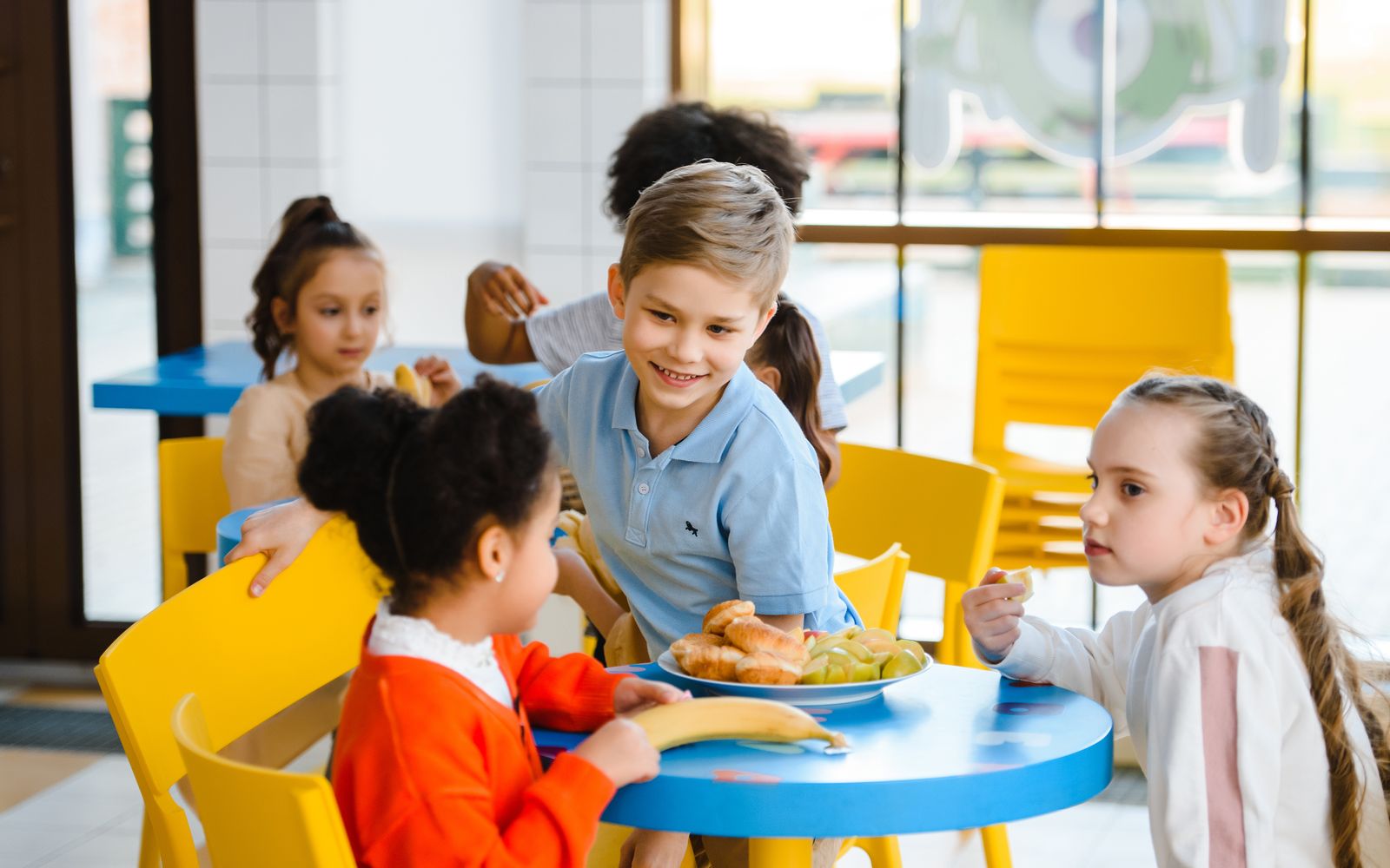 Children enjoying lunch together in a school cafeteria