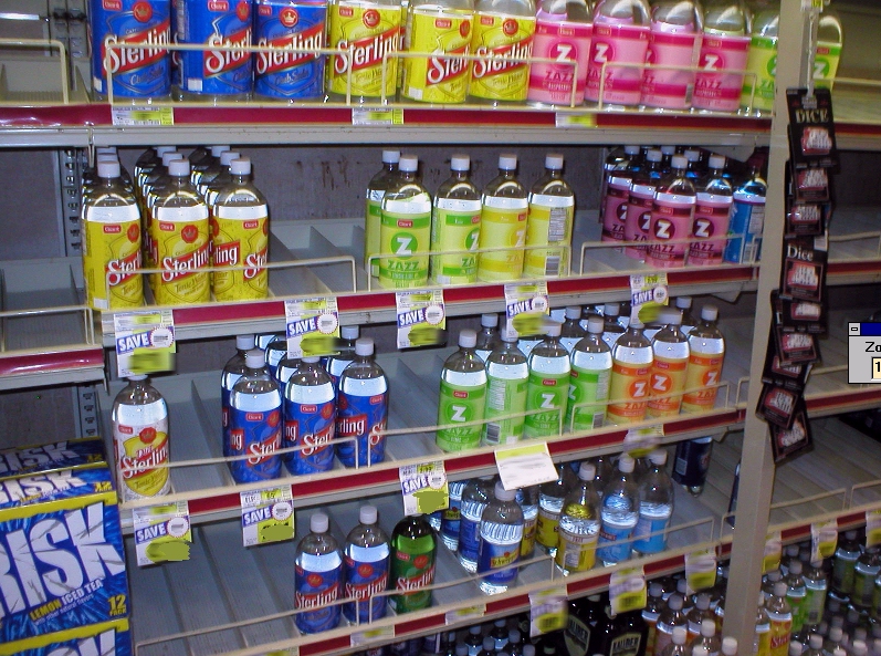 Bottles of soft drinks displayed on a store shelf