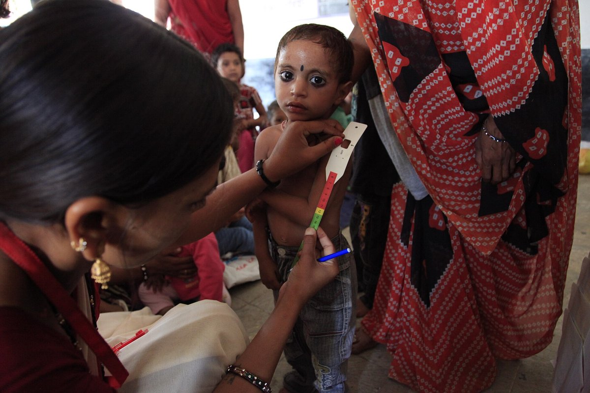 A health worker measures a young child's arm at an Anganwadi centre in Madhya Pradesh