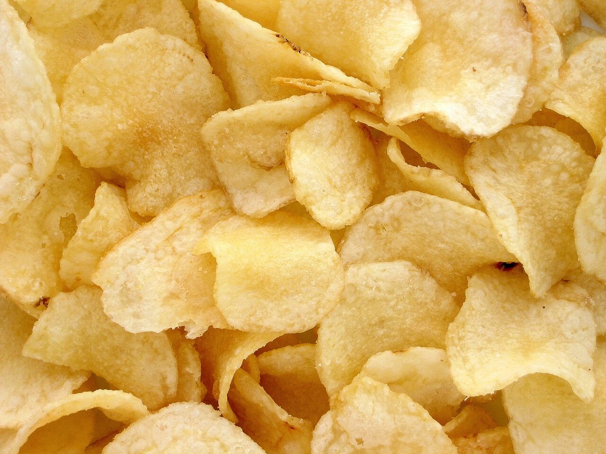 A close-up of a pile of potato chips